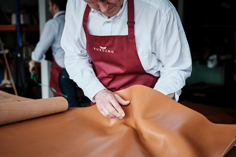 Alistair Tusting inspecting full-grain leather